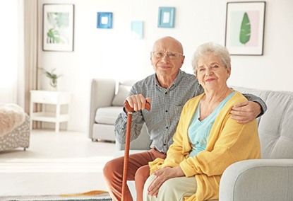 Older couple sitting on the sofa at home