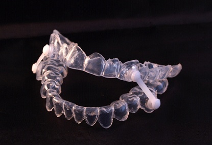 Oral appliance for snoring sitting on a black background